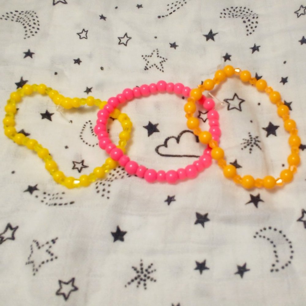Handmade pink, orange, and yellow accent bracelets.